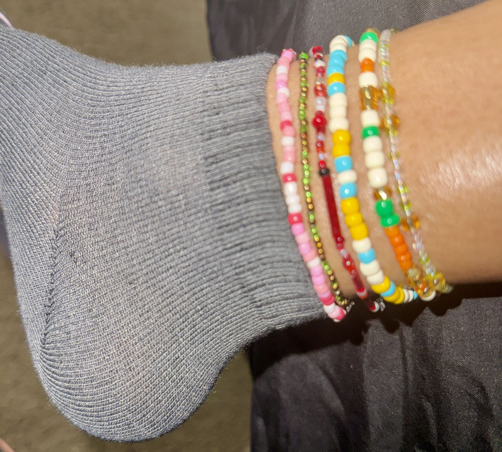 Customer wearing stackable bracelets as anklets